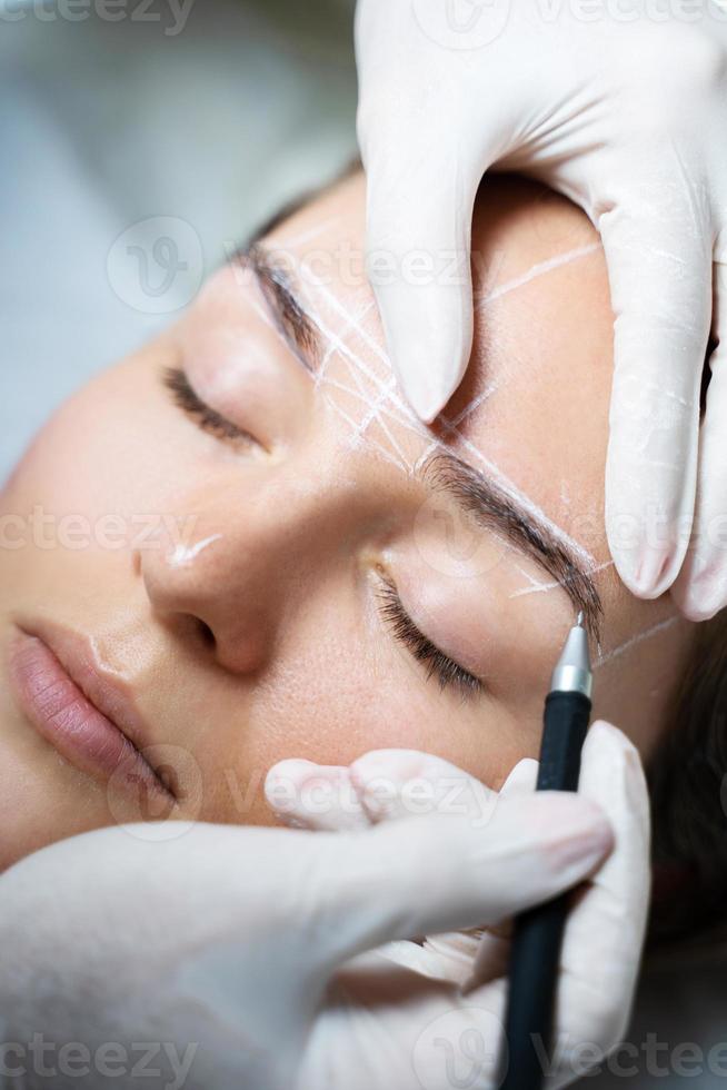 Woman during professional eyebrow mapping procedure 16264769 Stock