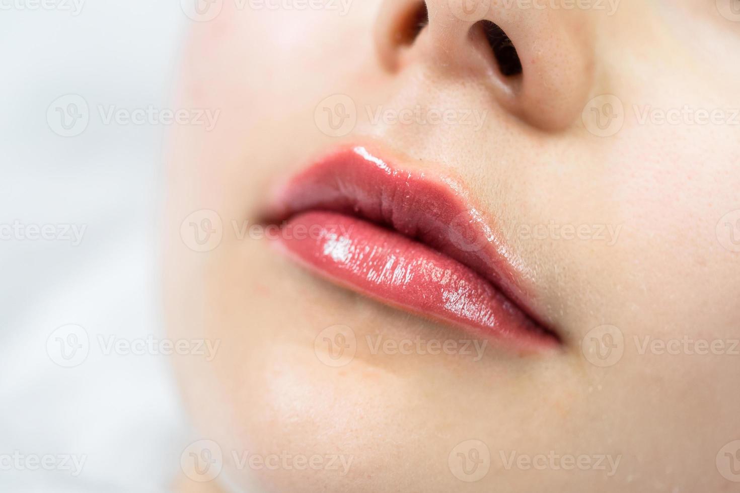 Female lips after permanent makeup lip blushing procedure photo