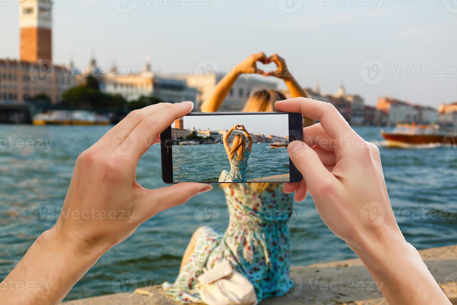 Hands capturing colorful beautiful landscape on smart phone during travels abroad photo