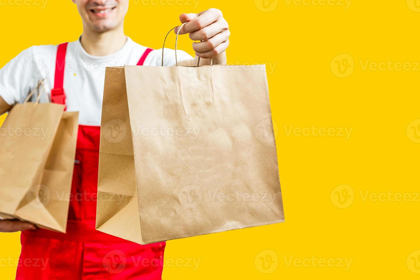 Diverse of paper containers for takeaway food. Delivery man is carrying photo