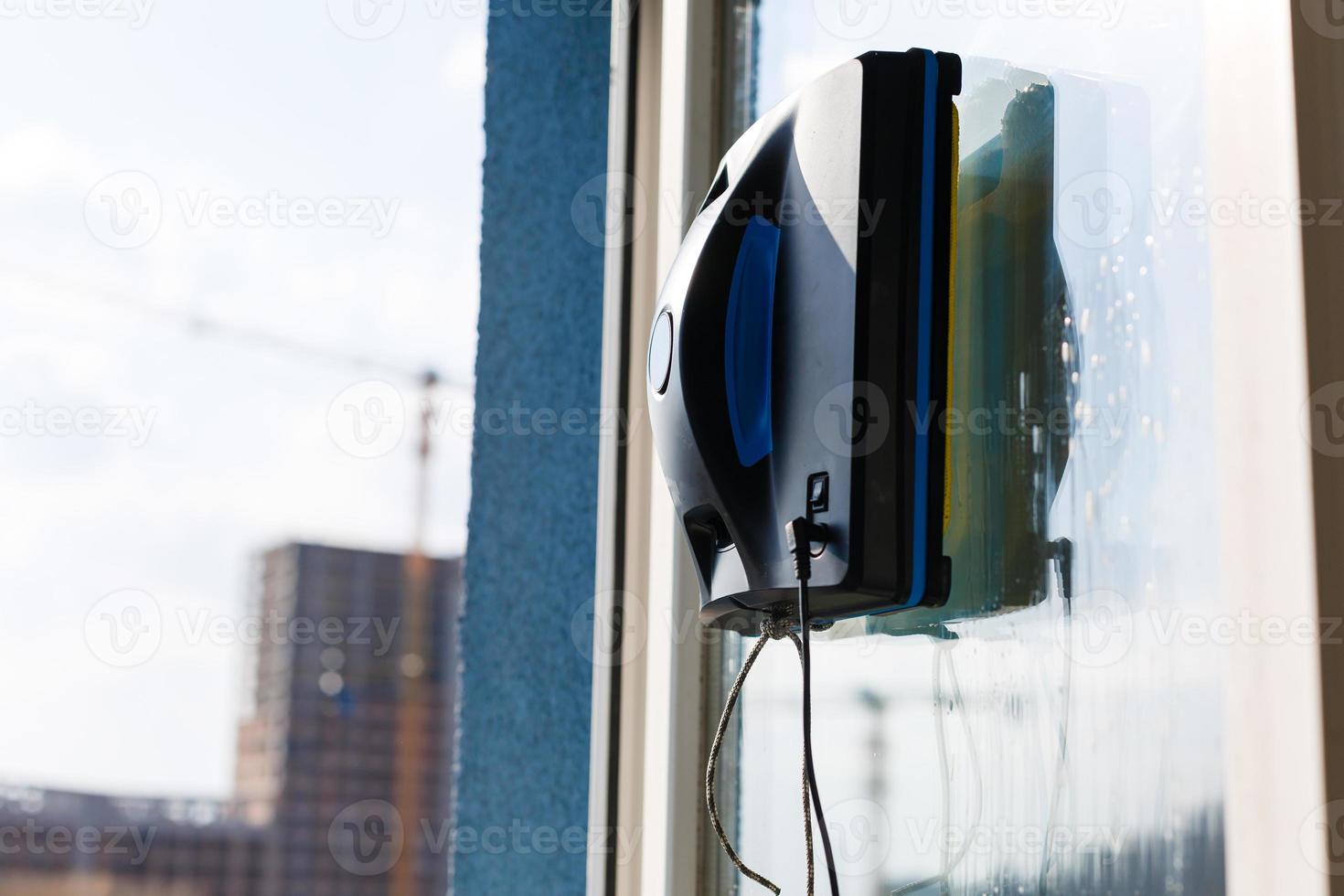 Robot window cleaner work on dirty window. Cleaning the house with