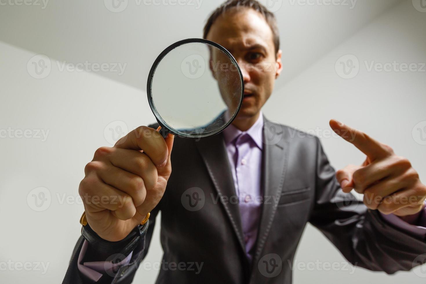 Man hand holding magnifying glass. Data search and analysis, conducting research, nuances, important details study, preparation for exams concept photo