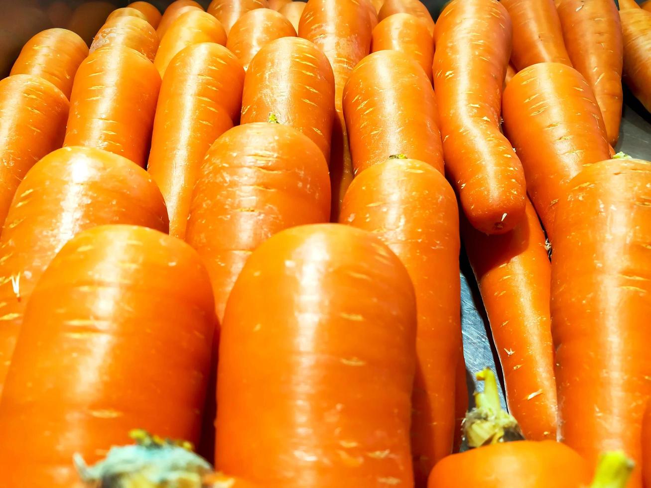 Fresh carrot in full screen background and wallpaper. photo