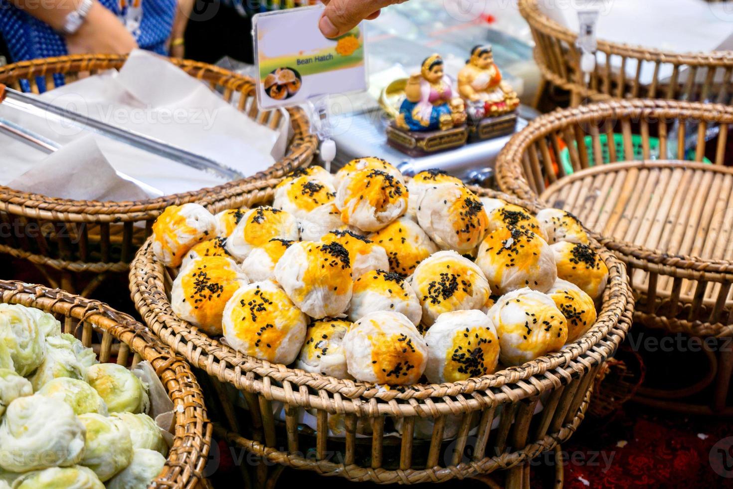 Closeup Chinese pastry moon cake sell in food market for Chinese new year, made with flour filling Most of them are clover with many sizes and is a dessert of luck in Chinese new year. photo