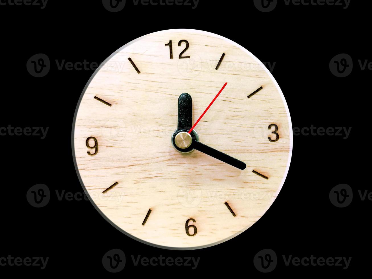 Wooden wall clock isolate on black background. photo