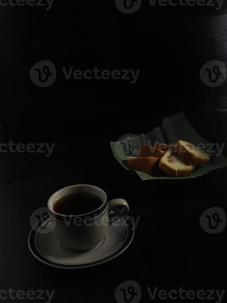 tea and cake on black background. Tea Time at home concept. photo