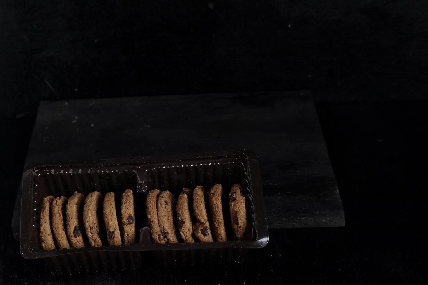 Chocolate chip cookies on black background photo