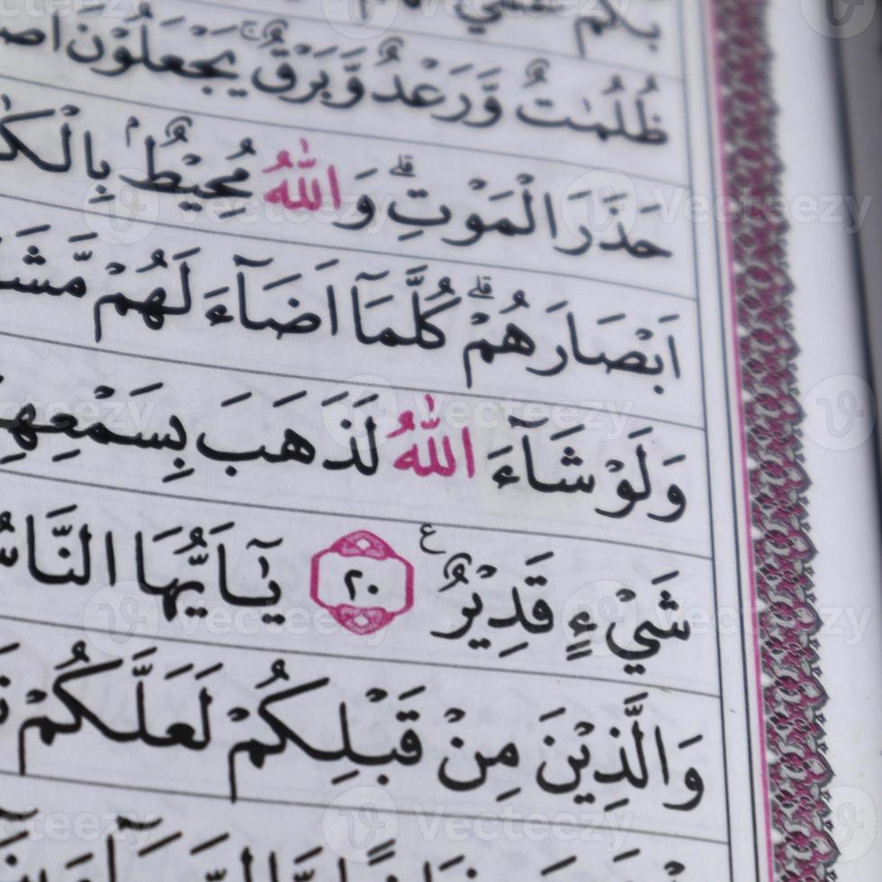 closeup on the verses of the Quran or Koran. focus on the red lafadz allah text photo