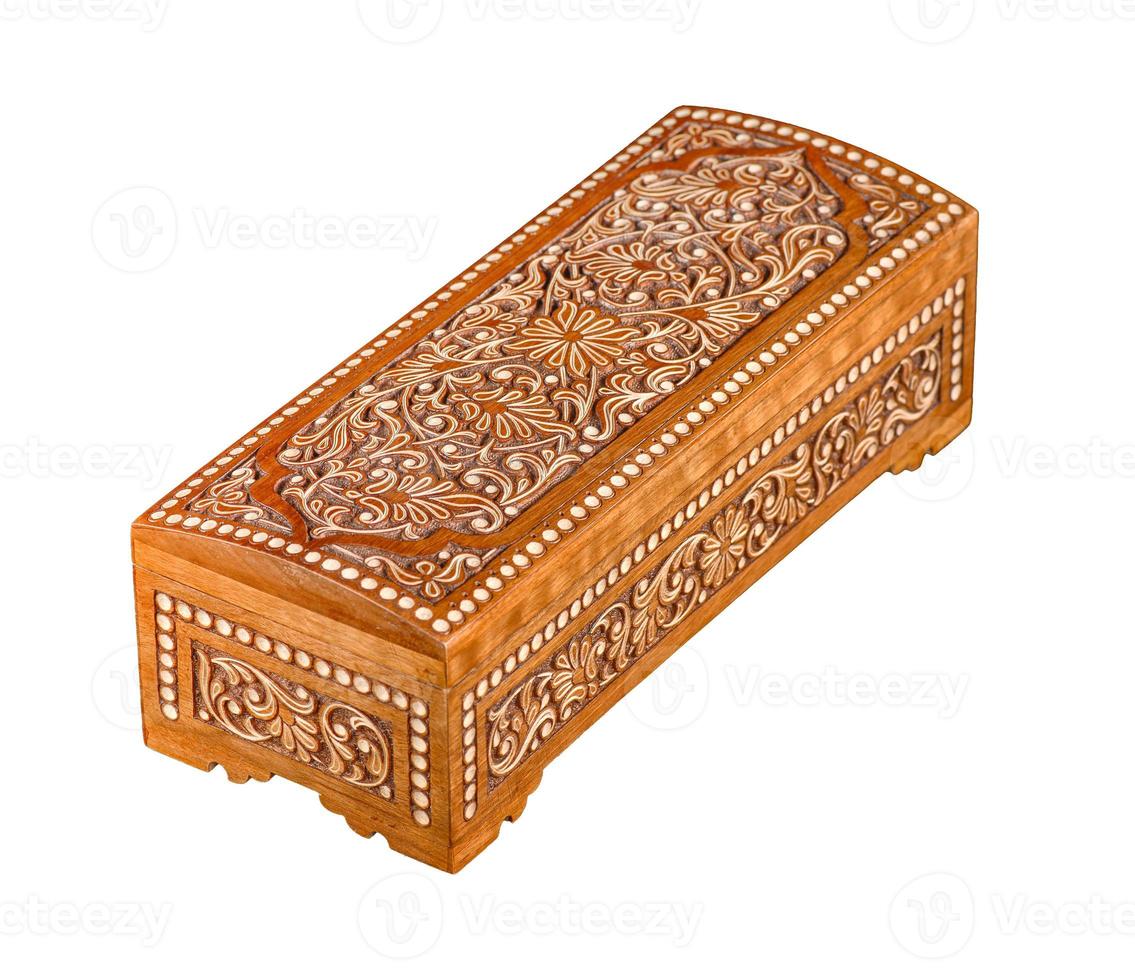 A wooden casket with traditional artistic carving isolated on a white background photo