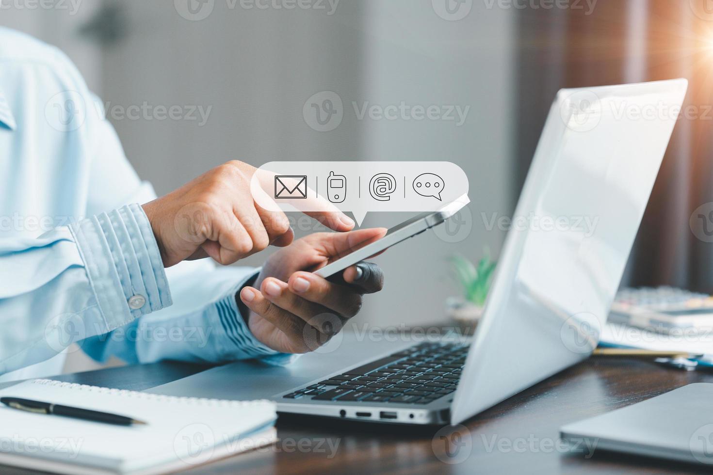 Businesswoman using phone and touching on virtual screen contact icons such as email, address, live chat, internet wifi. Contact us or Customer support hotline people connect. Connect with cyberspace. photo