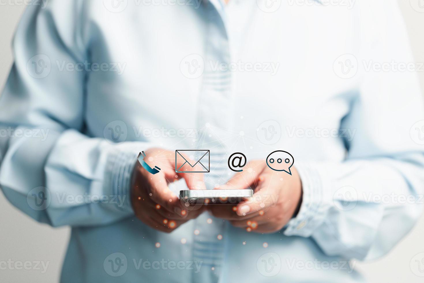 Businesswoman using phone and touching on virtual screen contact icons such as email, address, live chat, internet wifi. Contact us or Customer support hotline people connect. Connect with cyberspace. photo