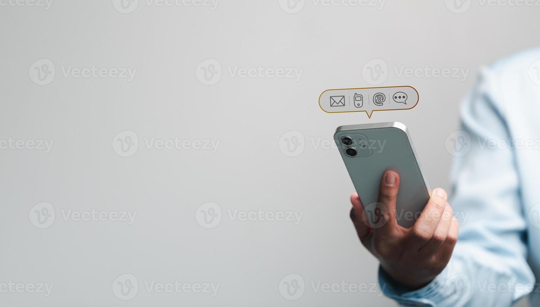 Businesswoman using phone and touching on virtual screen contact icons such as email, address, live chat, internet wifi. Contact us or Customer support hotline people connect. Connect with cyberspace. photo