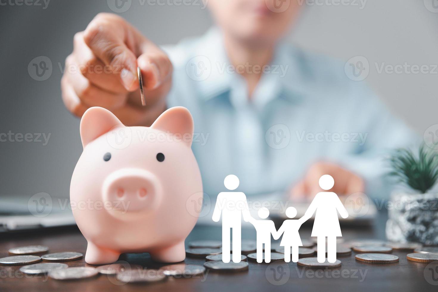 Businesswoman take a position to protect on the piggybank and paper family in hand, donation, saving, charity, family finance plan concept, fundraising, superannuation, financial crisis concept photo