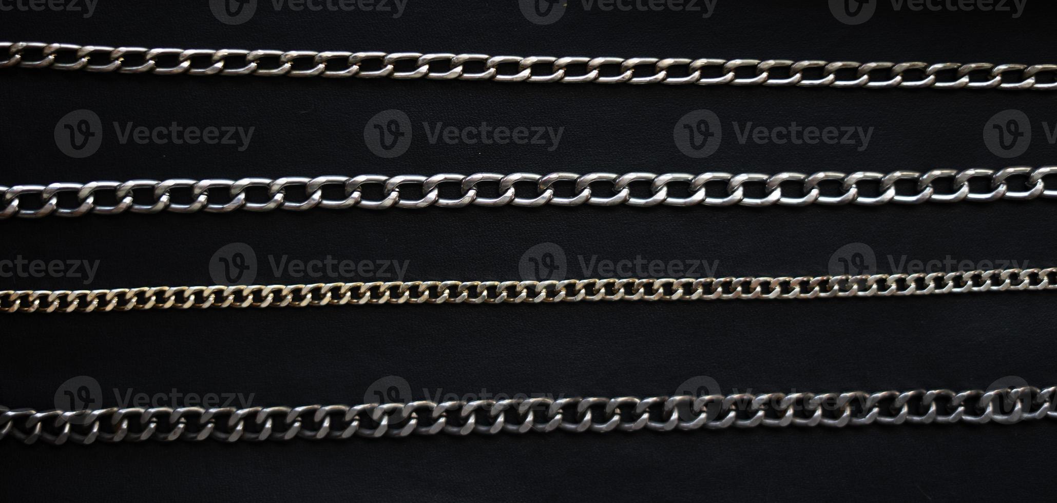 Set of chains isolated on black background photo