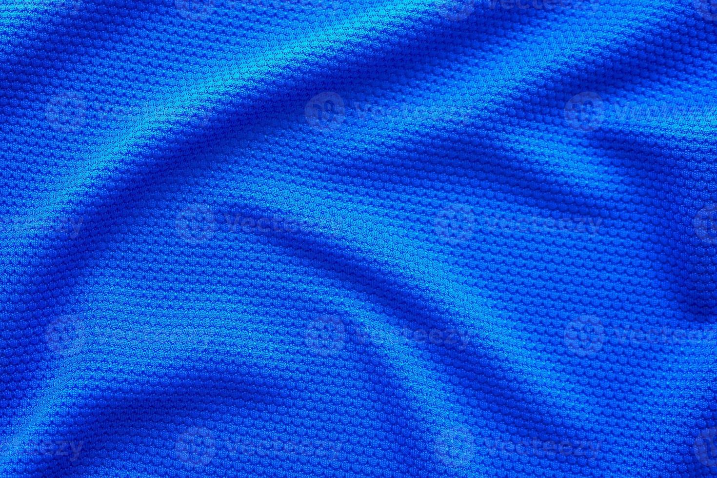 Blue football jersey clothing fabric texture sports wear background, close up top view photo