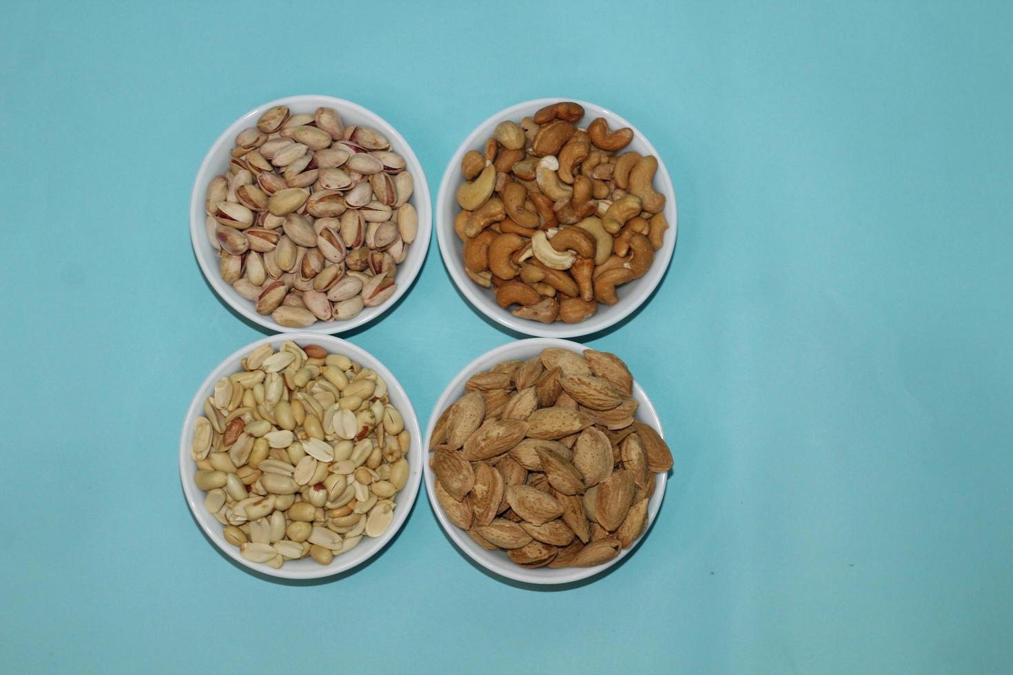 Different dried fruits and nuts on white background, top view. Space for text photo