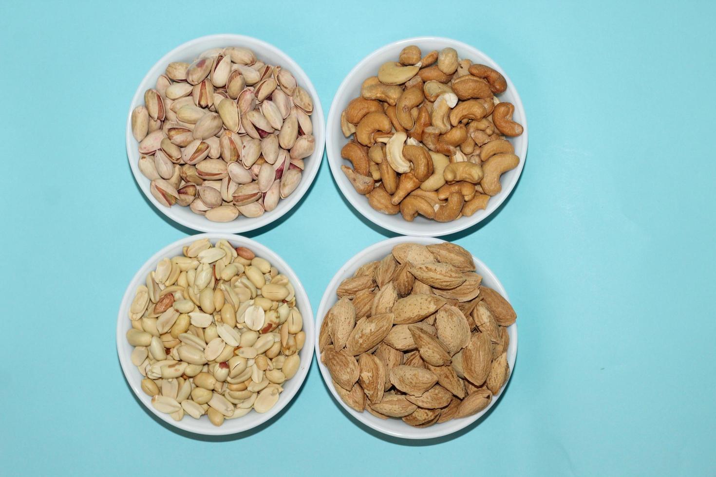 Different dried fruits and nuts on white background, top view. Space for text photo