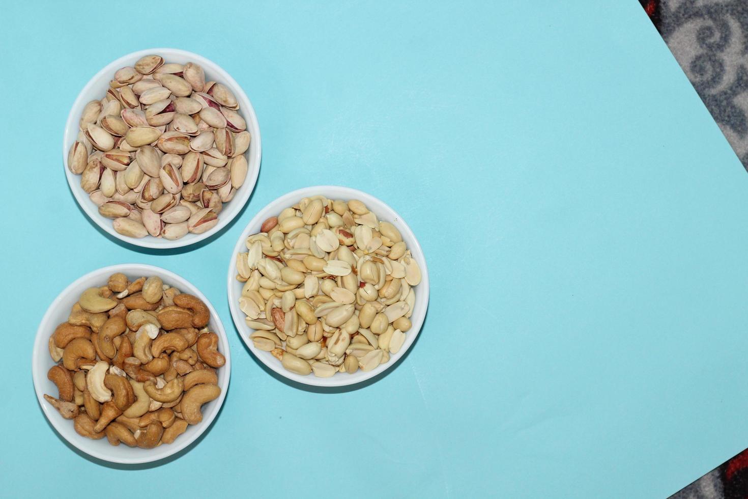 Different dried fruits and nuts on white background, top view. Space for text photo