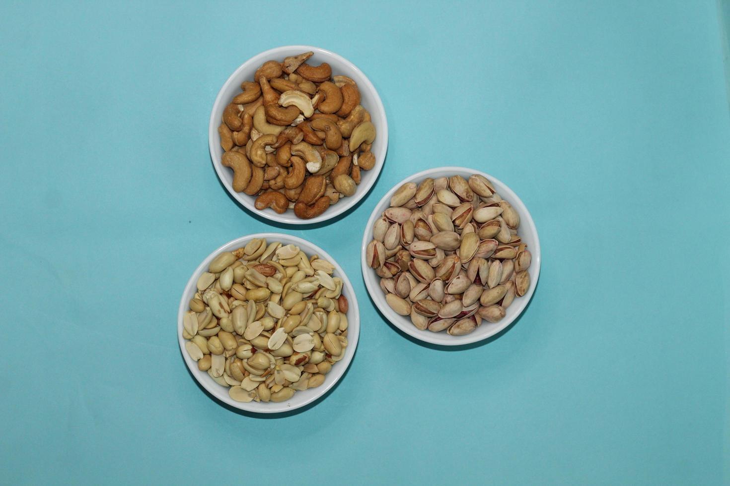 Different dried fruits and nuts on white background, top view. Space for text photo
