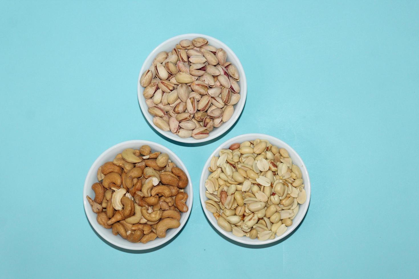Different dried fruits and nuts on white background, top view. Space for text photo