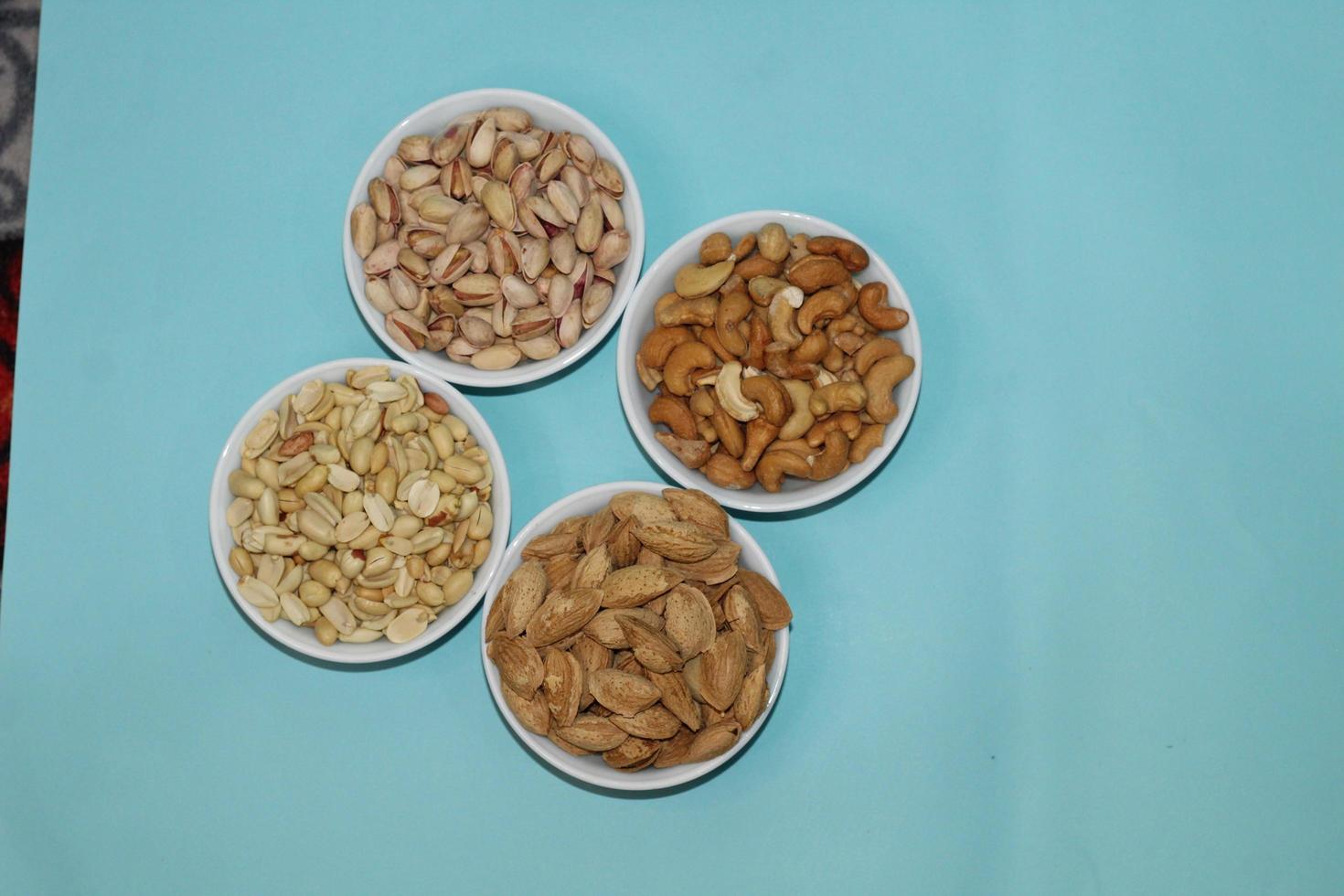 Different dried fruits and nuts on white background, top view. Space for text photo