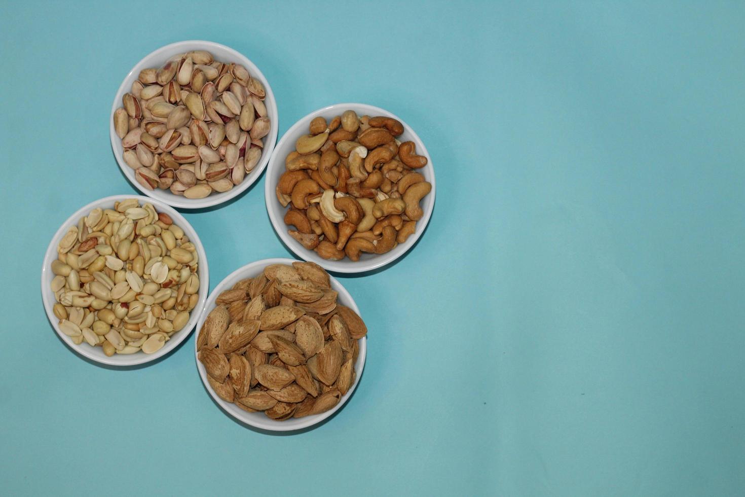 Different dried fruits and nuts on white background, top view. Space for text photo