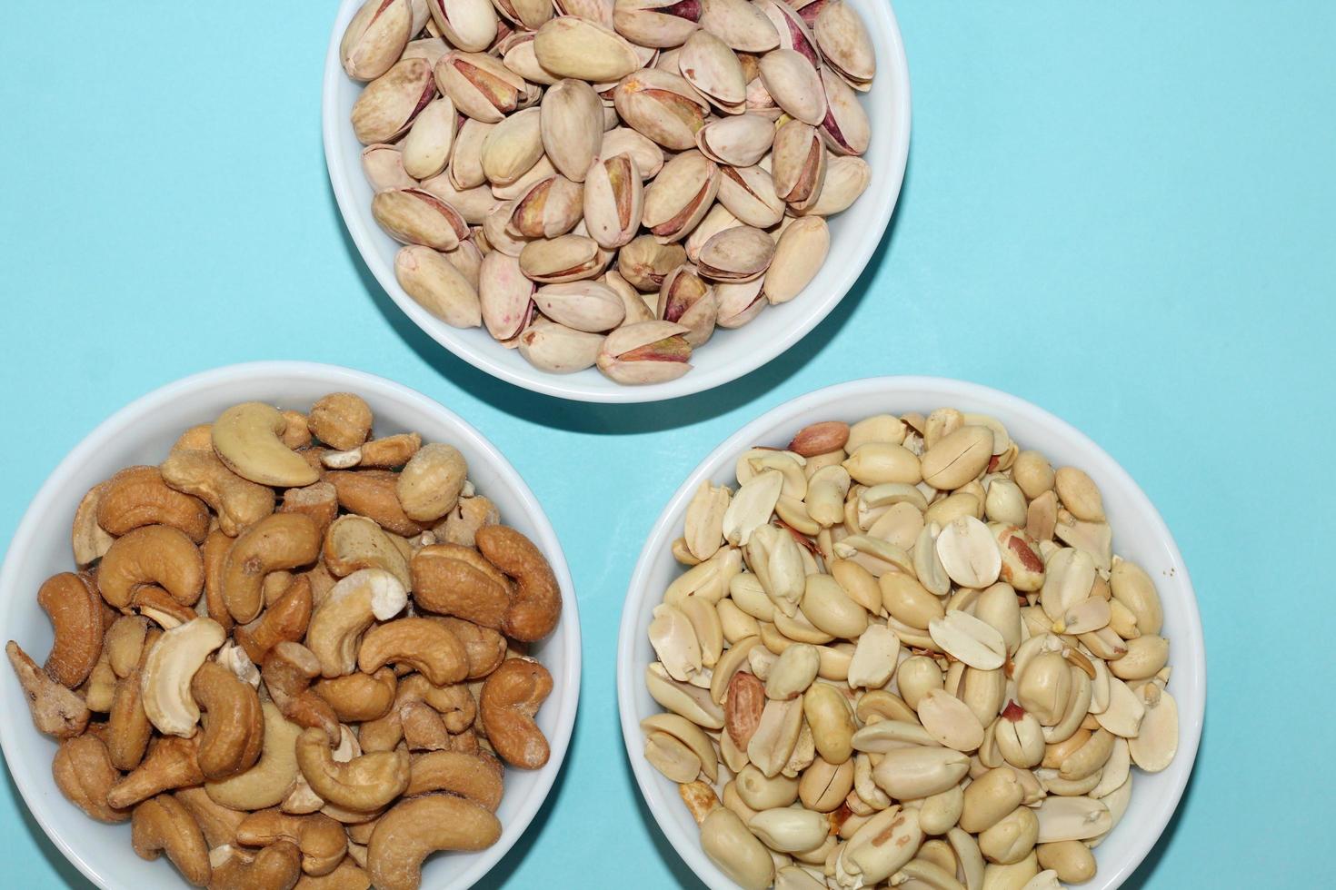 Different dried fruits and nuts on white background, top view. Space for text photo