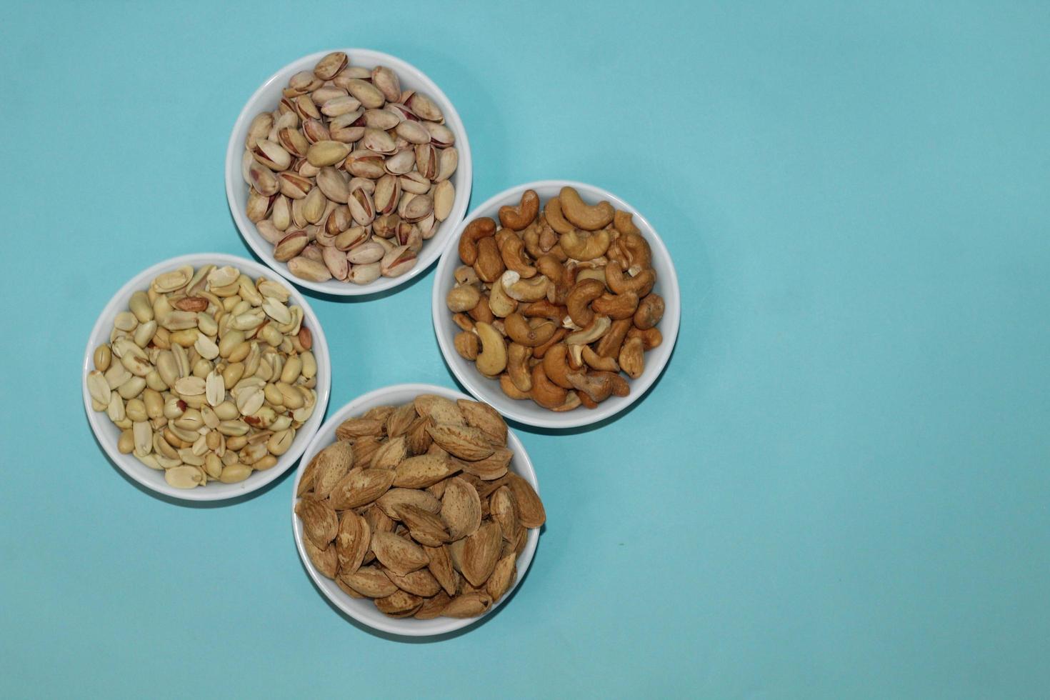 Different dried fruits and nuts on white background, top view. Space for text photo