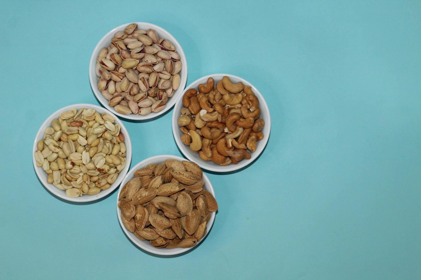 Different dried fruits and nuts on white background, top view. Space for text photo