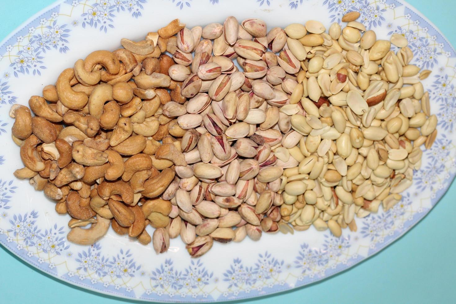 Different dried fruits and nuts on white background, top view. Space for text photo