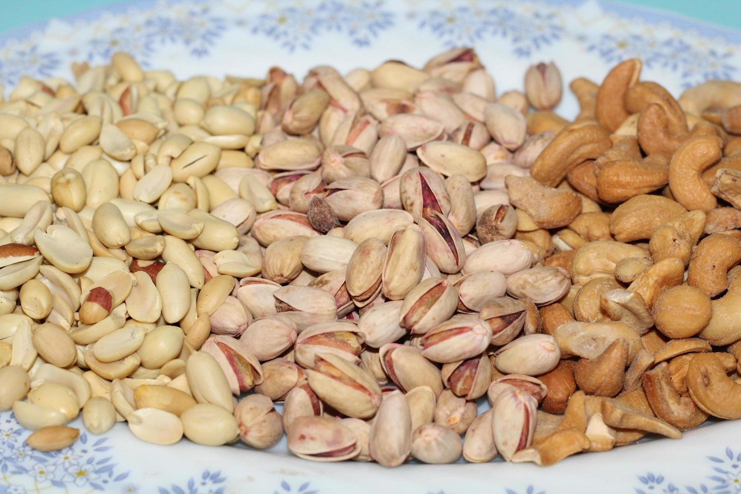 Different dried fruits and nuts on white background, top view. Space for text photo