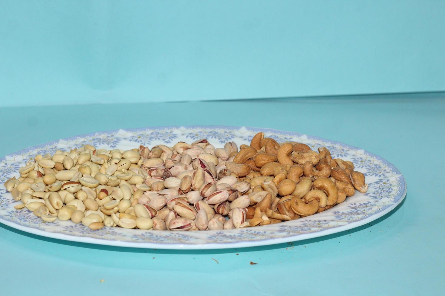 Different dried fruits and nuts on white background, top view. Space for text photo