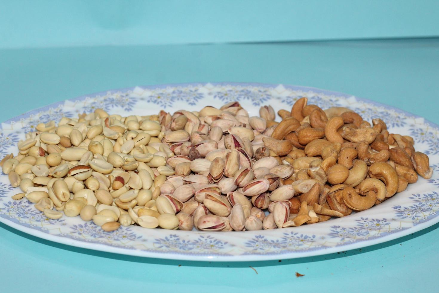 Different dried fruits and nuts on white background, top view. Space for text photo