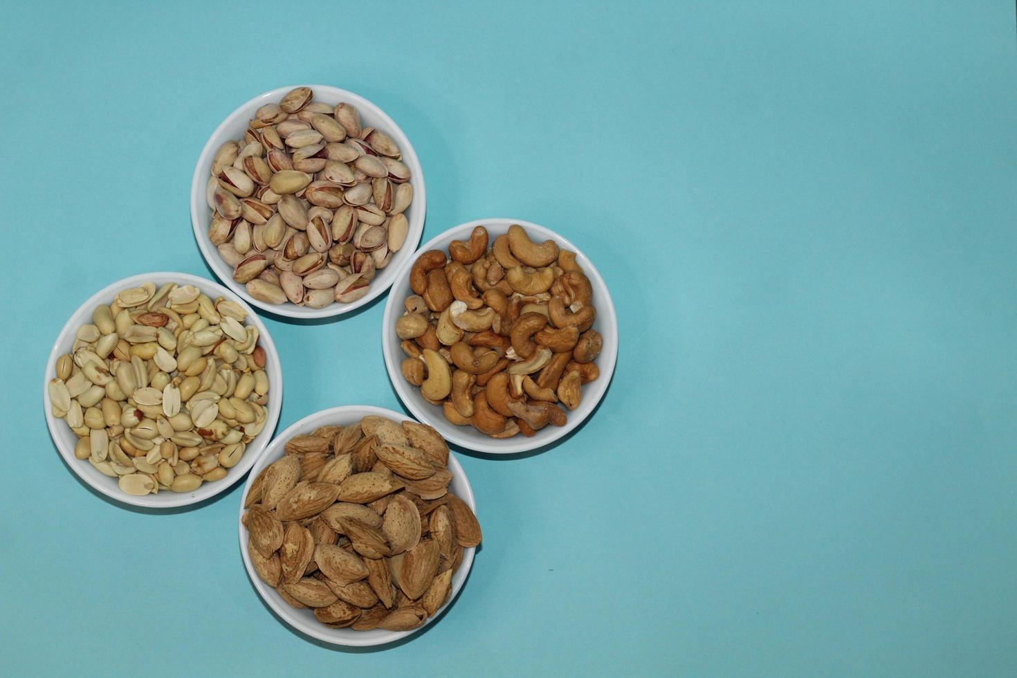 Different dried fruits and nuts on white background, top view. Space for text photo