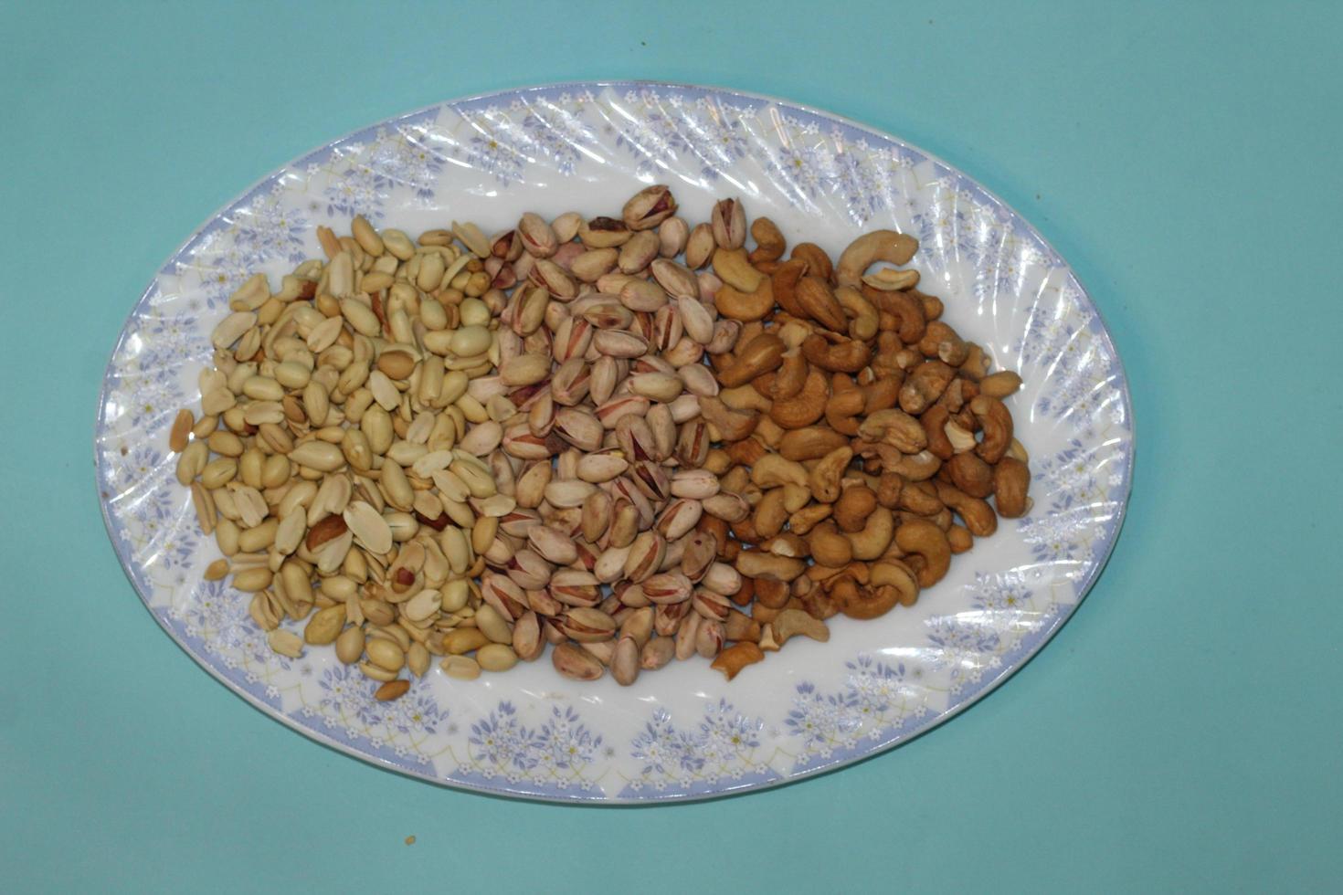 Different dried fruits and nuts on white background, top view. Space for text photo