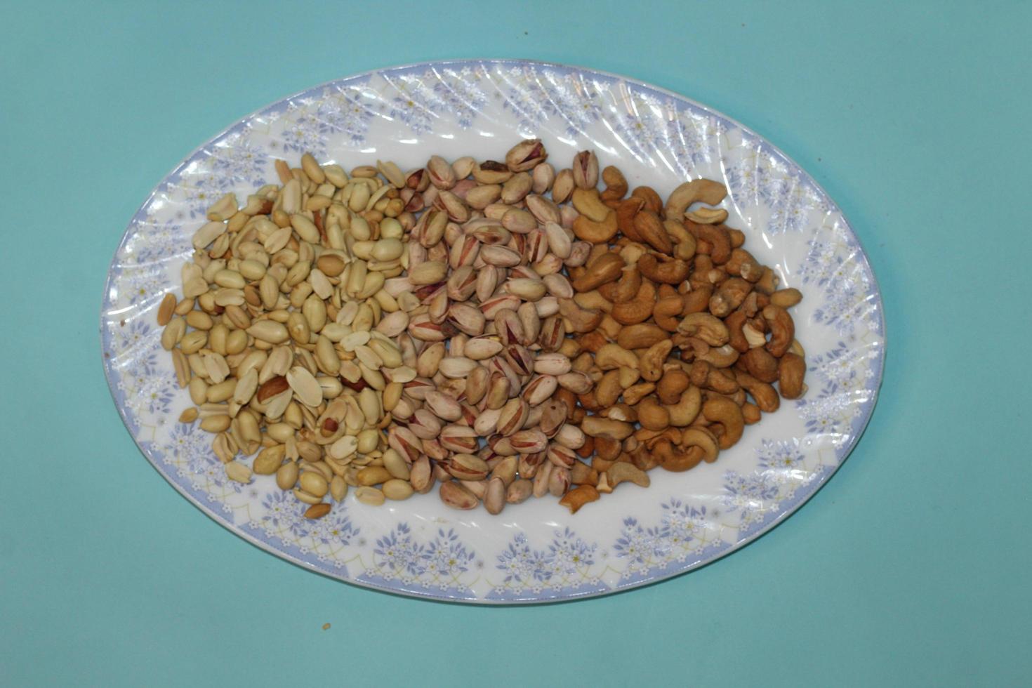 Different dried fruits and nuts on white background, top view. Space for text photo