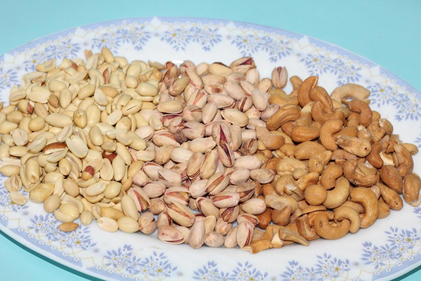 Different dried fruits and nuts on white background, top view. Space for text photo