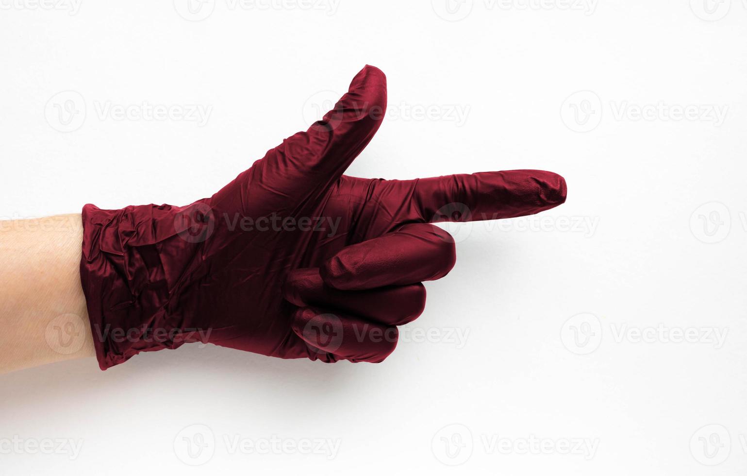 A hand in a surgical medical glove color Viva Magenta, highlighted on a white background. Production of rubber protective gloves.Hygiene and sanitary standards photo