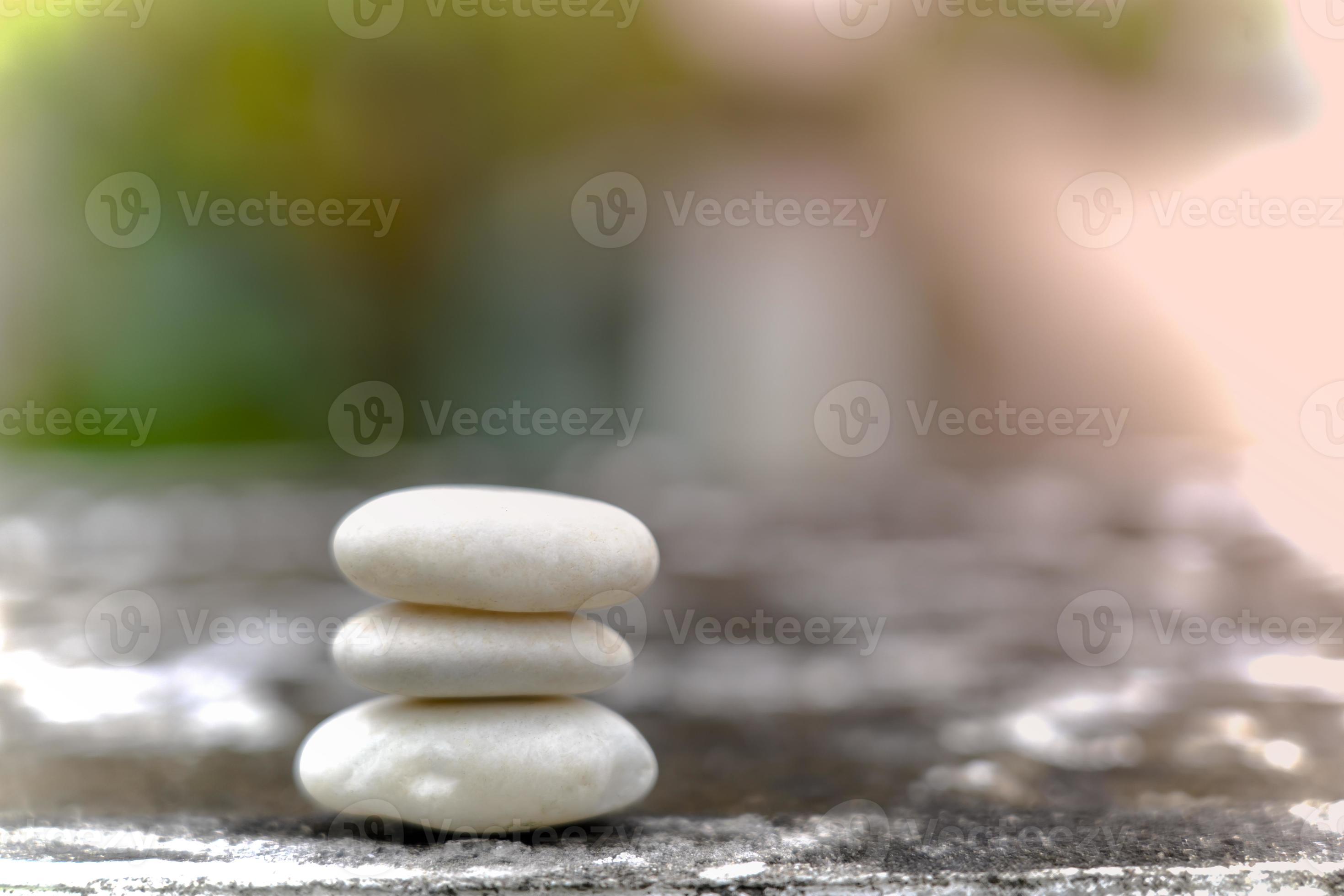 Meditation stones with rain drop water on cement floor on green