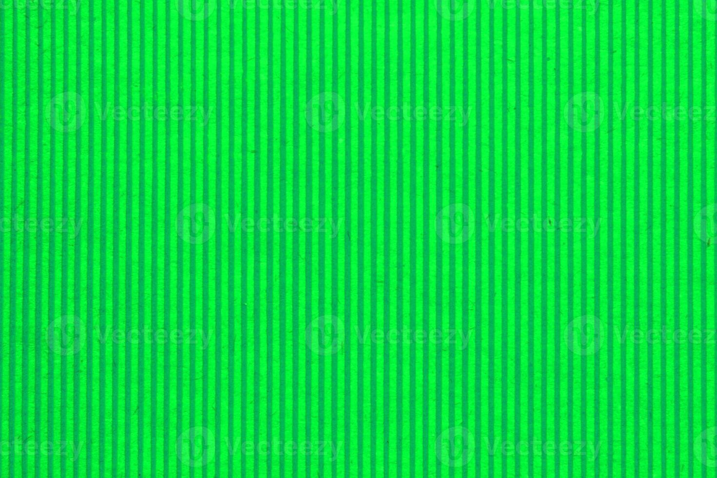 Abstract paper green geometric symmetrical texture striped surface vertical lines background. Structure design cardboard shape backdrop. Holiday spring decoration interior concept. Flatlay, close-up photo
