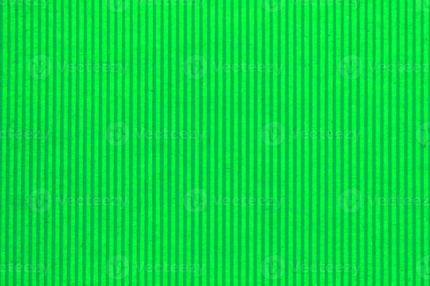 Abstract paper green geometric symmetrical texture striped surface vertical lines background. Structure design cardboard shape backdrop. Holiday spring decoration interior concept. Flatlay, close-up photo