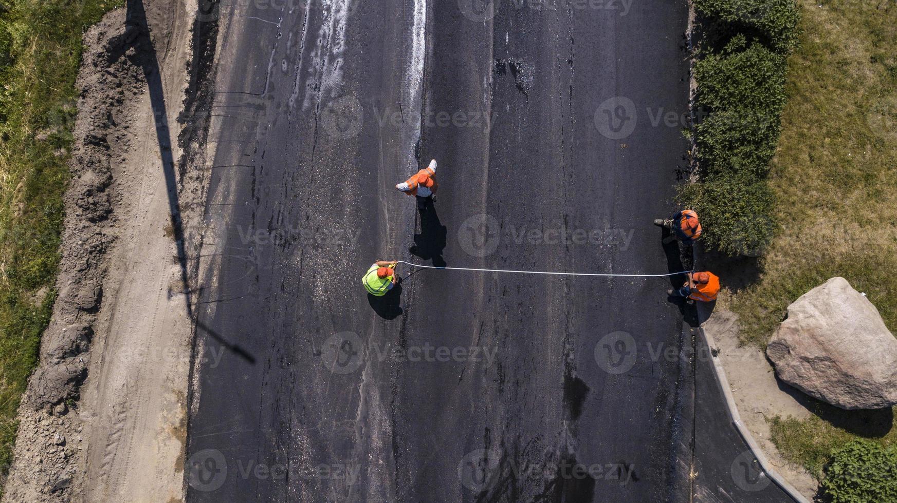 Aerial view on the new asphalt road under construction photo