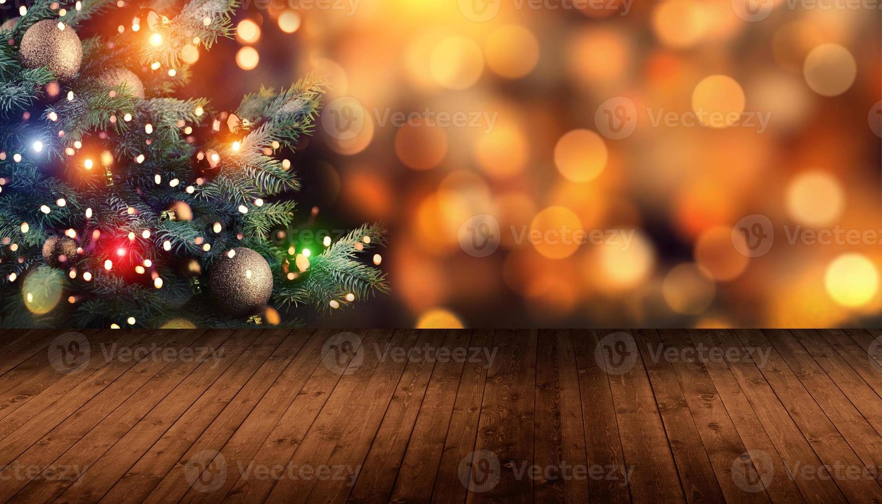Christmas Tree with illumination near the fireplace. Blurred Background with illumination lights on wooden background photo
