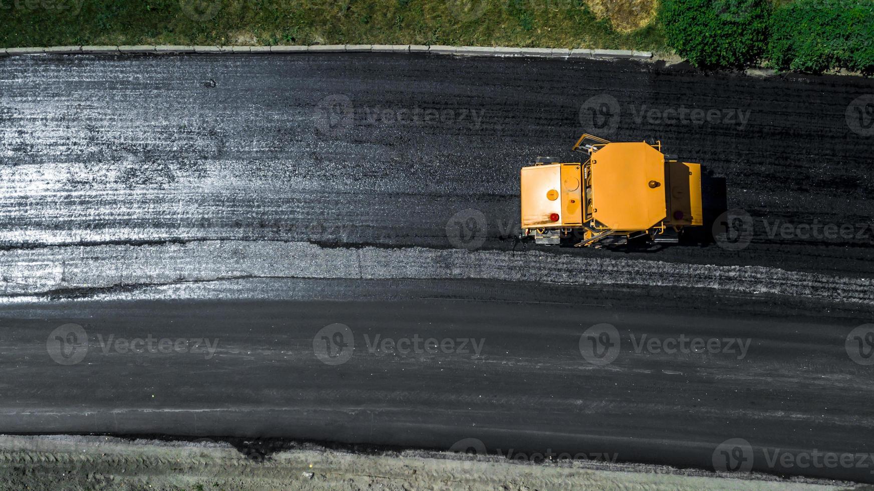 Aerial view on the new asphalt road under construction photo