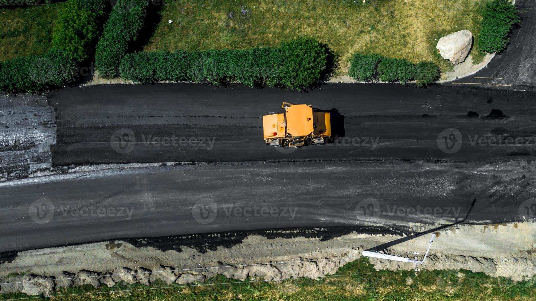 Aerial view on the new asphalt road under construction photo