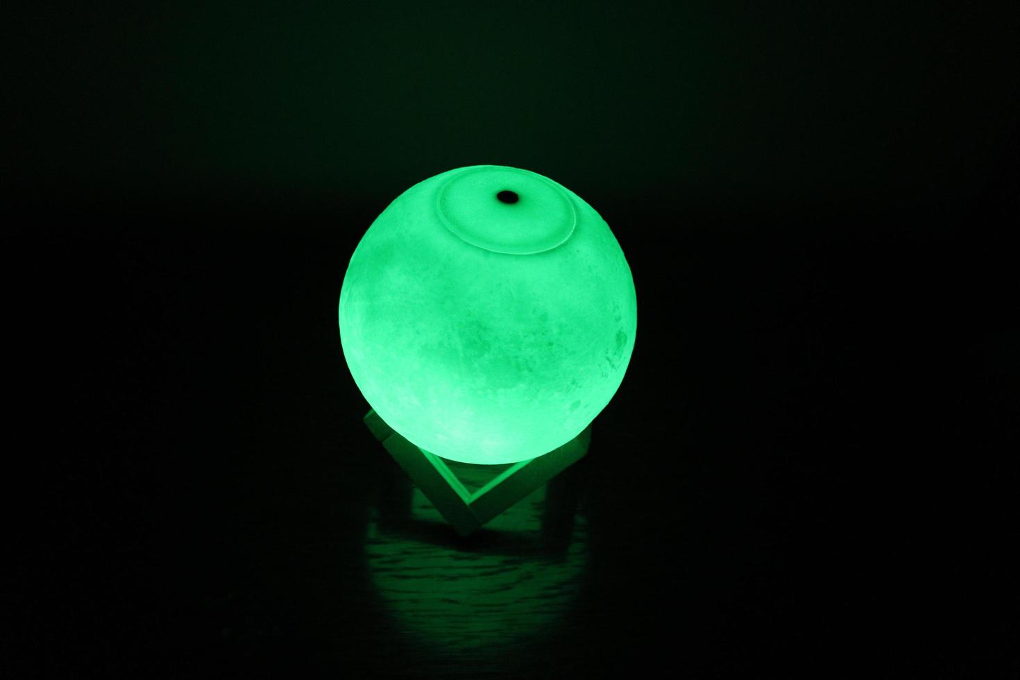 Complex moon lamp that has different colors concepts.This lamp also has a brown support that makes it stand still photo