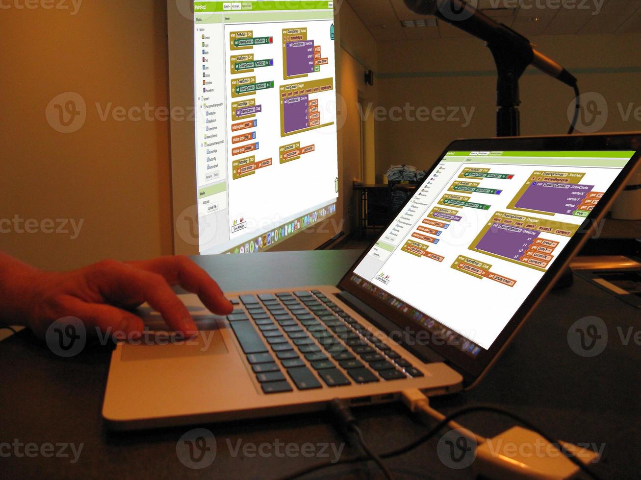 Coding training with the screen that the teacher who teaches coding reflects on the wall with a projection device.Writing Codes Sitting at Desk. Programmer Writing Data Code. photo