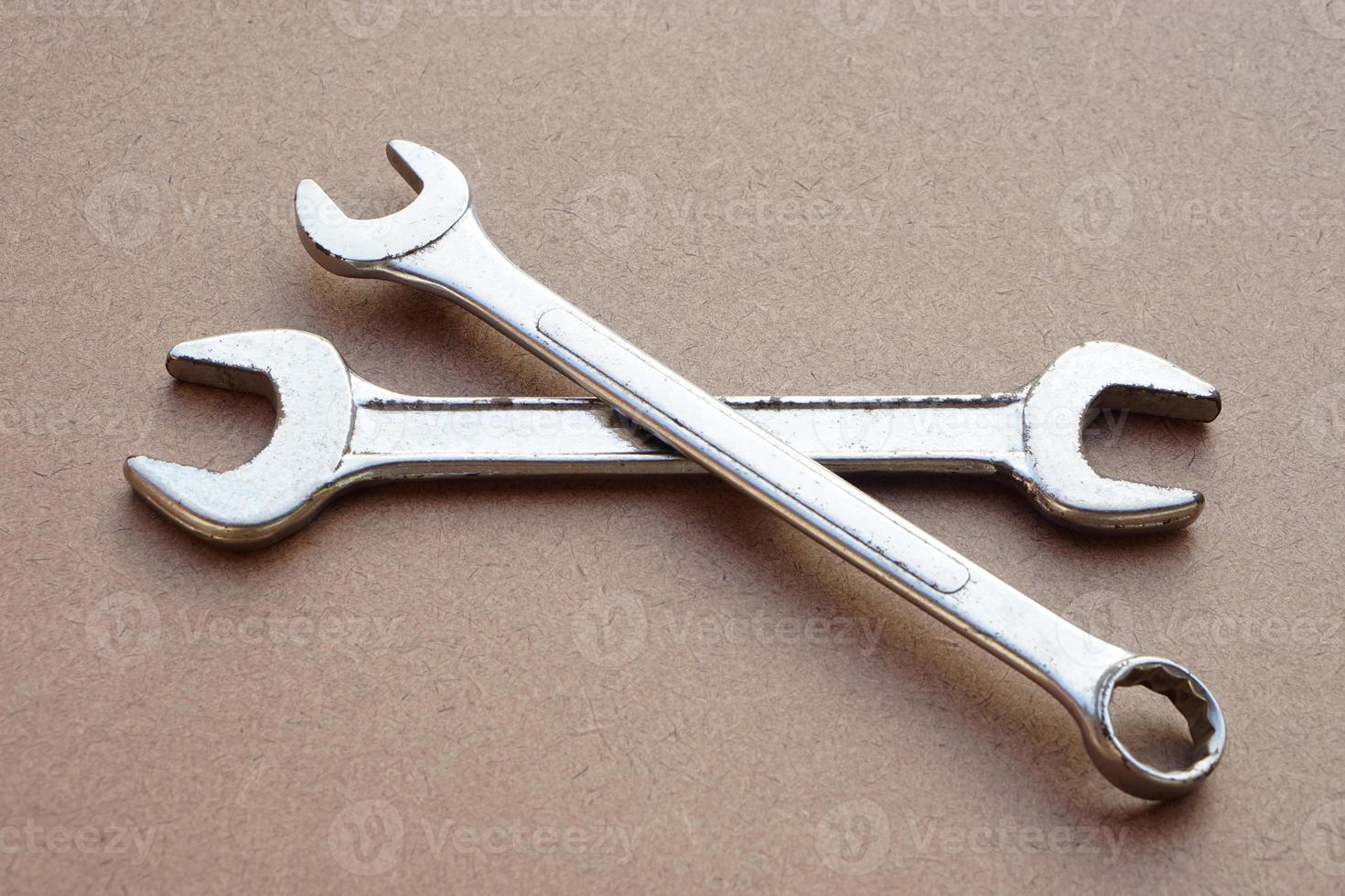 Two  metal wrench isolated on brown. Concept, handyman, mechanic tools. Spanners. Equipment for fixing or repairing, renovation in daily life. photo