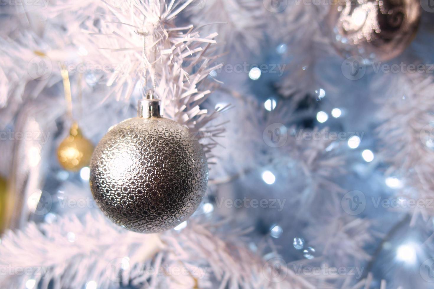 Shiny gold and silver christmas spheres on christmas tree with space for text photo