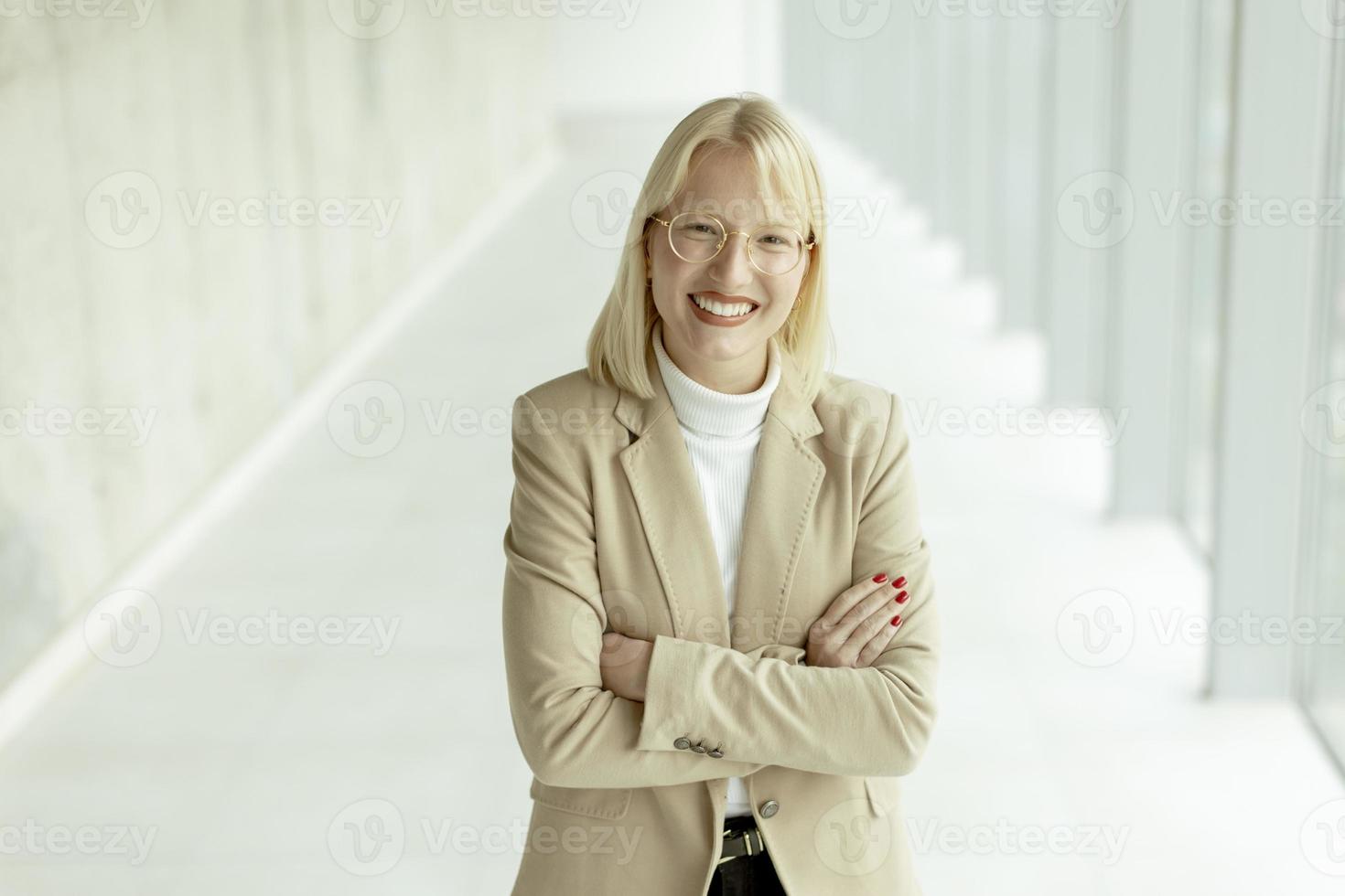 Business woman standing in the office corridor photo